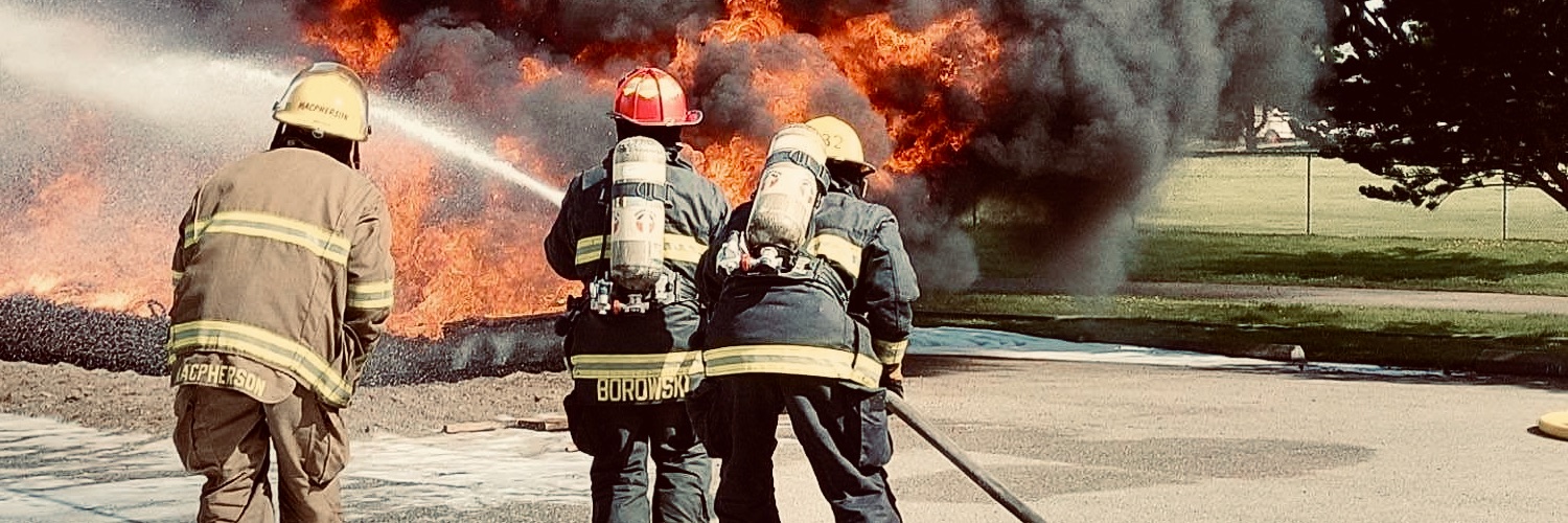 Firefighters spraying water on a fire